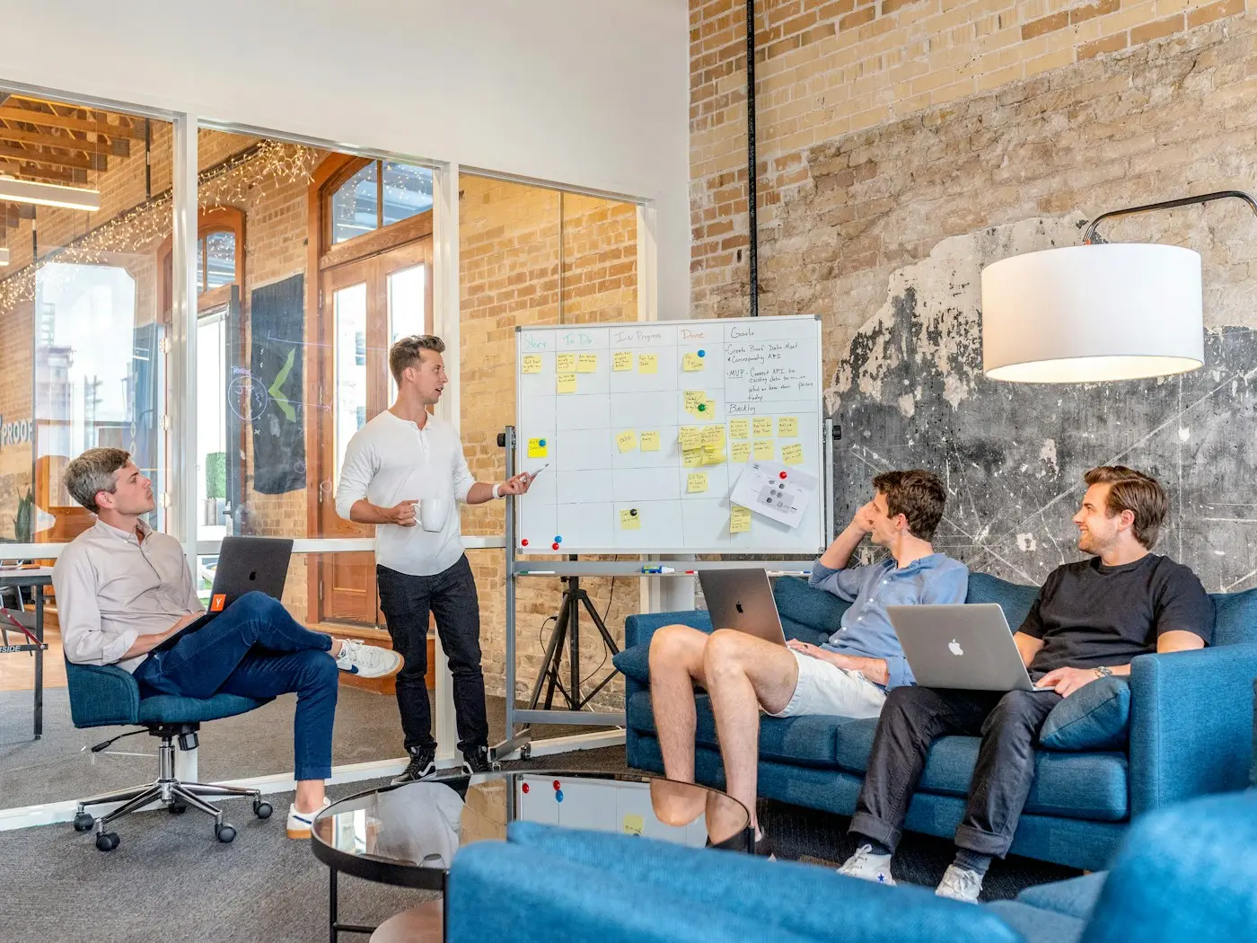 A team gathered round a whiteboard in a bright studio.